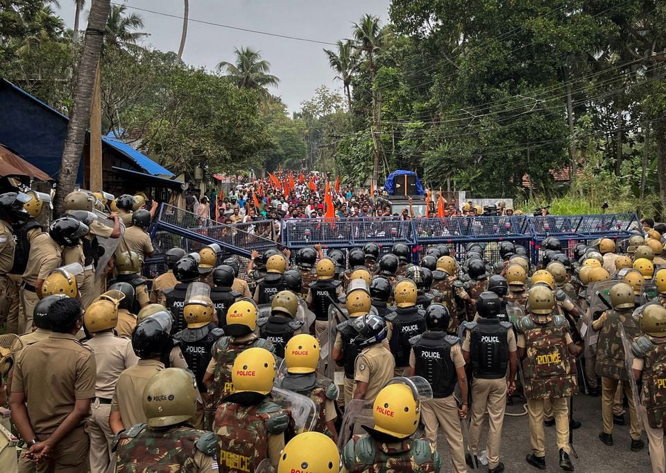 police officers stand guard near the barricades during a protest rally by the supporters of the proposed vizhinjam port project in the southern state of kerala india november 30 2022 reuters munsif vengattil file photo