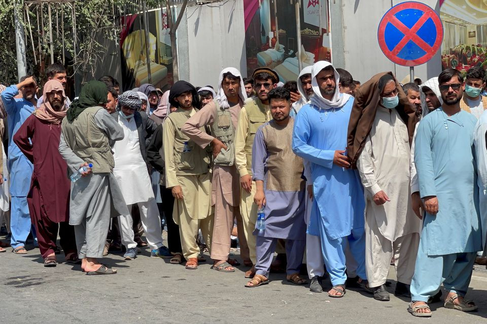 afghans line up outside a bank to take out their money after taliban takeover in kabul afghanistan september 1 2021 reuters