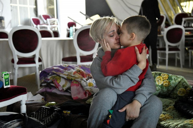 egor 5 comforts his mother helen yakubets who cries in a ballroom which has been converted to a temporary shelter at the mandachi hotel after fleeing from chernihiv in ukraine to romania following russia s invasion of ukraine at the border crossing in suceava romania march 20 2022 her 18 year old son and husband remain in ukraine to fight reuters egor 5 comforts his mother helen yakubets who cries in a ballroom which has been converted to a temporary shelter at the mandachi hotel after fleeing from chernihiv in ukraine to romania following russia s invasion of ukraine at the border crossing in suceava romania march 20 2022 her 18 year old son and husband remain in ukraine to fight reuters