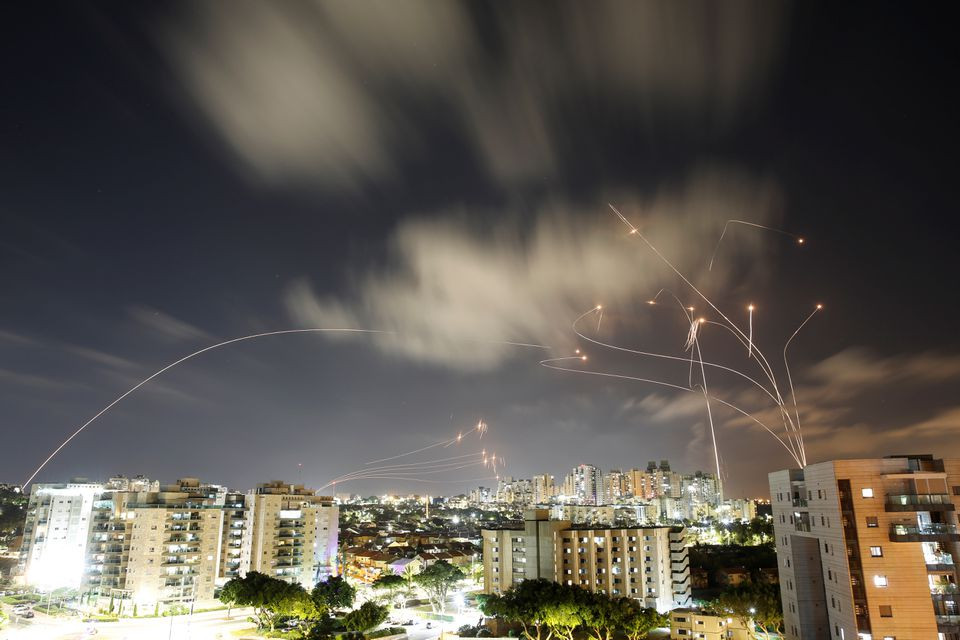 Streaks of light are seen as Israel's Iron Dome anti-missile system intercepts rockets launched from the Gaza Strip towards Israel, as seen from Ashkelon, Israel. PHOTO: REUTERS