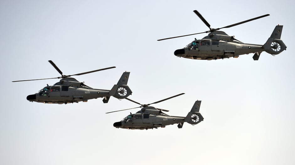 Navy helicopters fly past during a Pakistan Day military parade. PHOTO: AFP