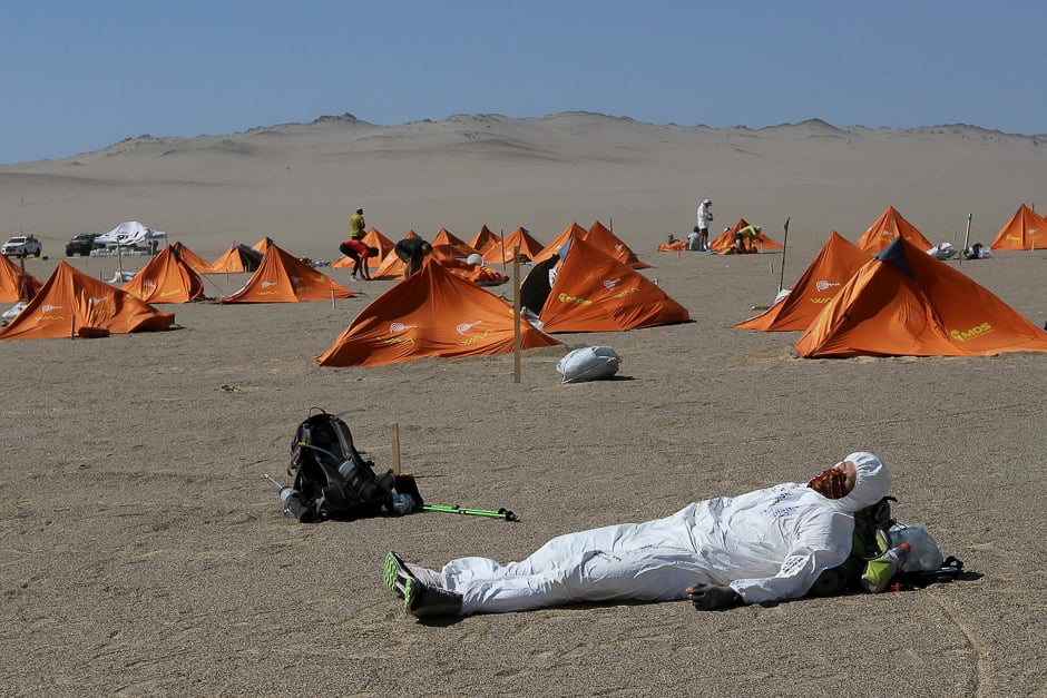 A runner rests during the Marathon des Sables in Paracas, Peru. PHOTO: REUTERS