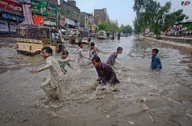 Children playing with accumulated rainwater. PHOTO: S Akber