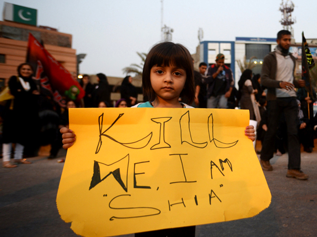 a pakistani shia muslim girl holds placard during a protest against the twin bombings in quetta in karachi pakistan on january 13 2013 photo afp