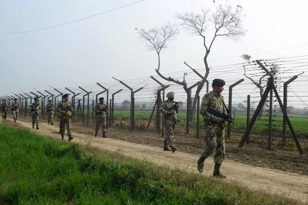 indian border security force soldiers patrol along the india pakistan border fence about 27 km from wagah on january 13 2013 photo afp file indian border security force soldiers patrol along the india pakistan border fence about 27 km from wagah on january 13 2013 photo afp file