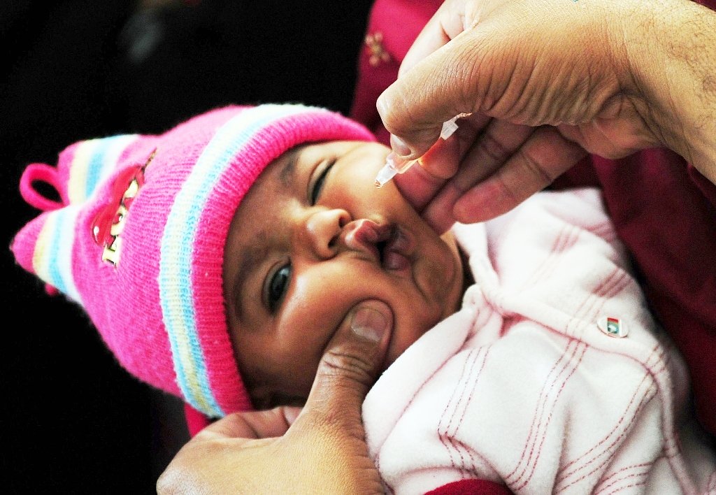 a pakistani health worker administers polio vaccine drops to a young child at a polio vaccination center in karachi photo afp file