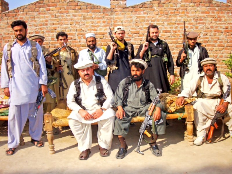 deceased adezai peace militia founding member dilawar khan left and late militia member israr khan right are pictured with their bodyguards after a meeting photo express