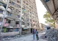 locals stand next to a damaged building in catia la mar la guaira state venezuela photo reuters
