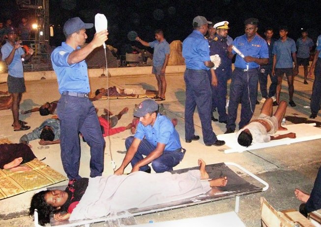 sri lankan sailors assist rescued survivors on a sri lanka navy vessel at oluvil fisheries harbour in eastern sri lanka photo afp