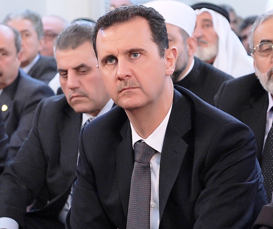 a handout picture released by the official syrian arab news agency on january 24 2013 shows syria 039 s embattled president bashar al assad sitting during a prayer to mark the birth of islam 039 s prophet mohammed in damascus photo afp