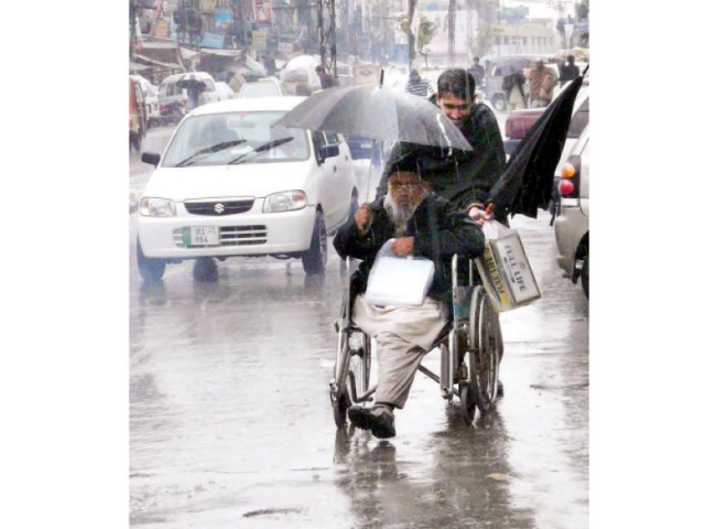 a man on a wheelchair being helped along the street photo nni a man on a wheelchair being helped along the street photo nni