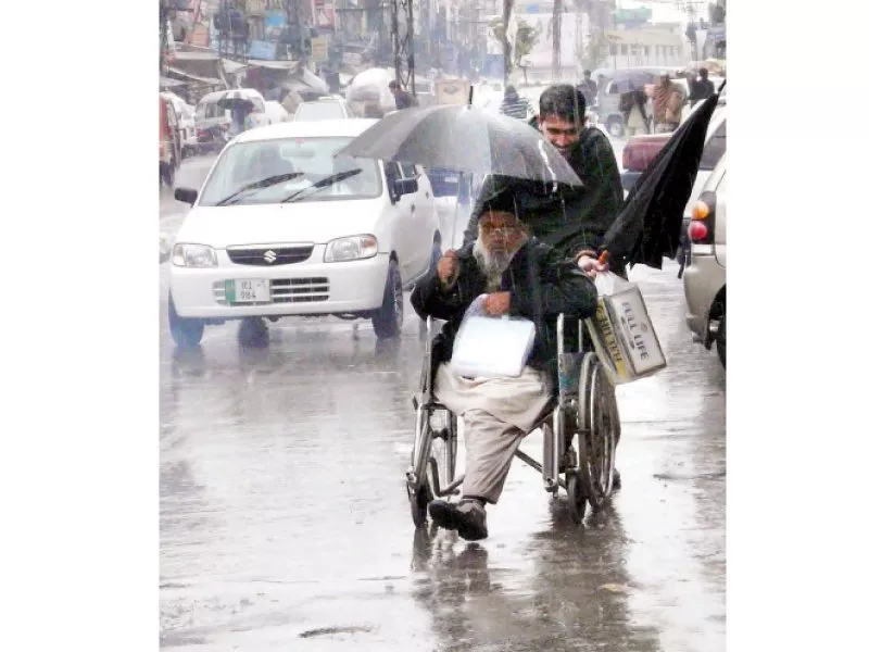 a man on a wheelchair being helped along the street photo nni a man on a wheelchair being helped along the street photo nni