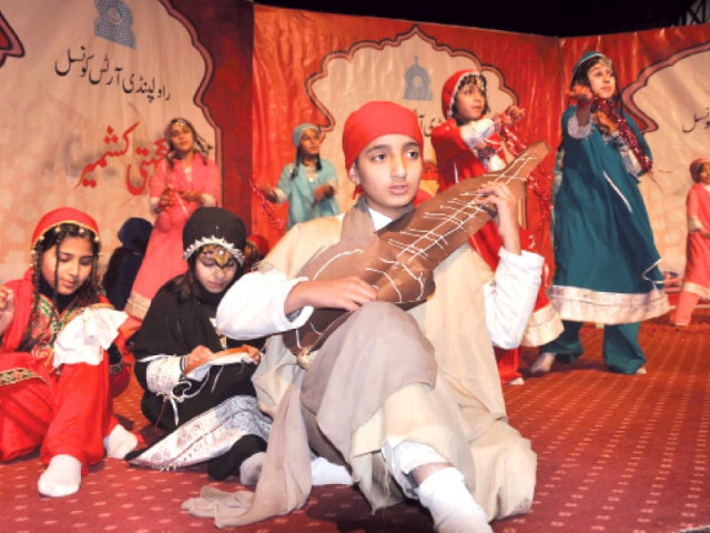 students performing folk tunes and dance at rac top kashmiri dolls and handicrafts on display at lok virsa photo express students performing folk tunes and dance at rac top kashmiri dolls and handicrafts on display at lok virsa photo express