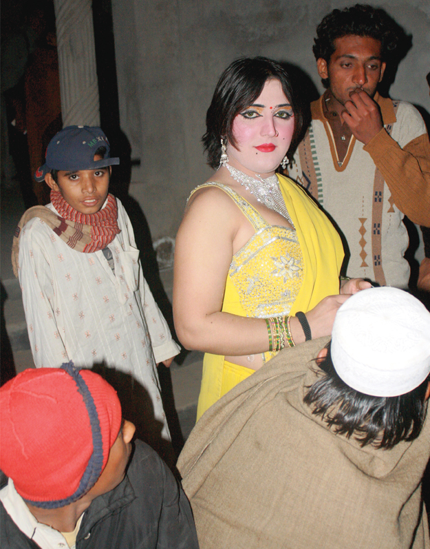 eight flamboyantly dressed eunuchs danced and gyrated to pashto music as the men cheered and hooted
