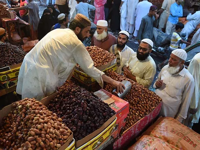 karachi residents buy dates from a shop at a market in karachi on the eve of ramazan photo afp karachi residents buy dates from a shop at a market in karachi on the eve of ramazan photo afp