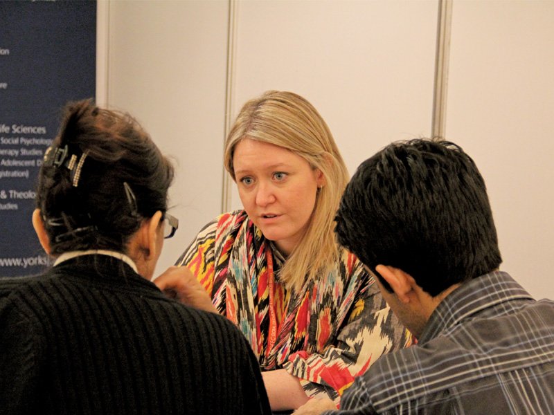 several students discussed the prospect of further studies at uk study fair 2013 on thursday above mairead kelly the international operations in charge at york st john university gives a brochure to an interested student photo ayesha mir express