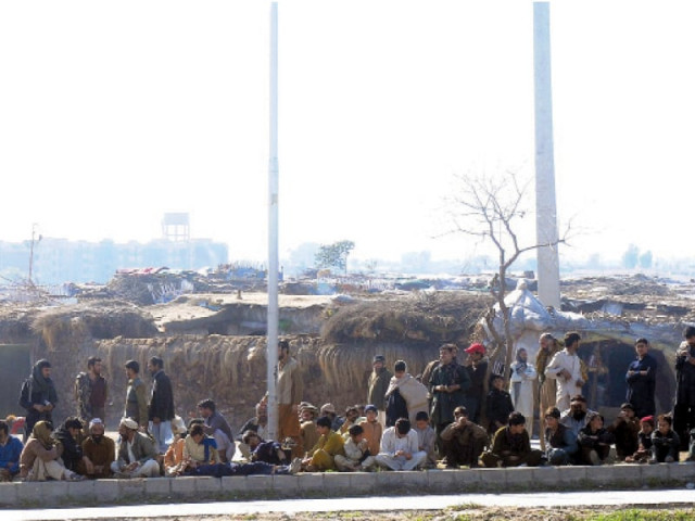 the residents of afghan basti in sector i 11 resist eviction notices served by cda photo express the residents of afghan basti in sector i 11 resist eviction notices served by cda photo express