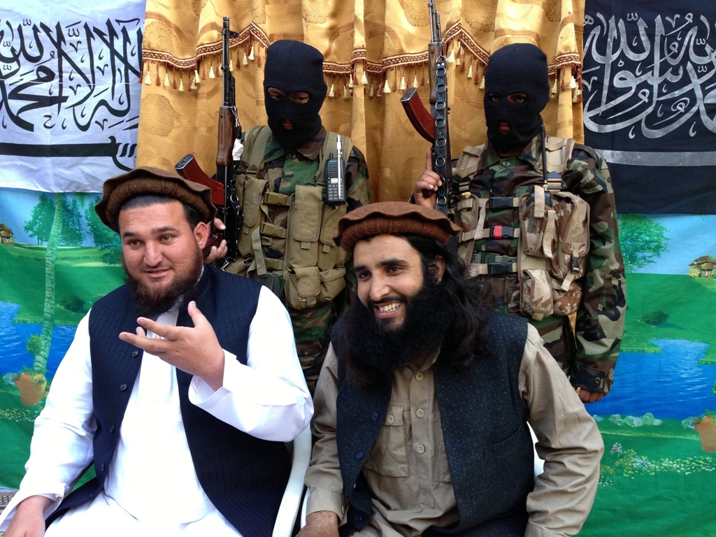 tehreek e taliban pakistan ttp spokesperson ehsanullah ehsan l and with new ttp member adnan rasheed address a press conference in shabtoi a village in south waziristan on february 2 2013 photo afp