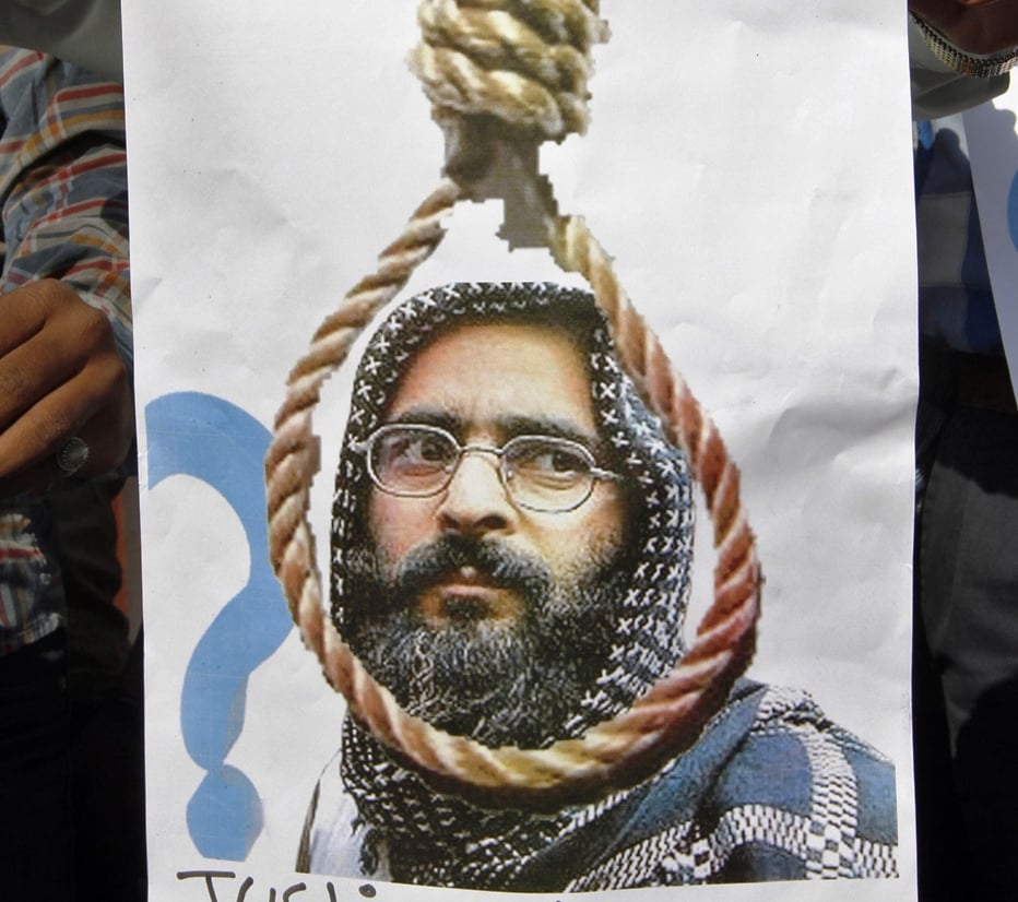 a member of a social group holds a placard with a picture of afzal guru before burning it during a protest in the western indian city of ahmedabad december 13 2011 photo reuters