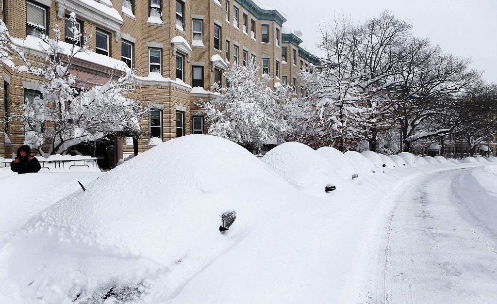 snow covered vehicles sit on commonwealth avenue on february 9 2013 in the brighton neighborhood of boston massachusetts photo afp