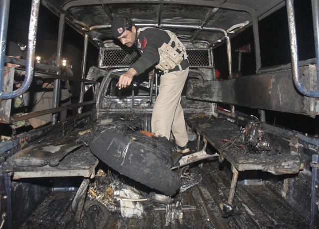 a policeman collects evidence from a police vehicle after a hand grenade attack in peshawar february 10 2013 photo reuters