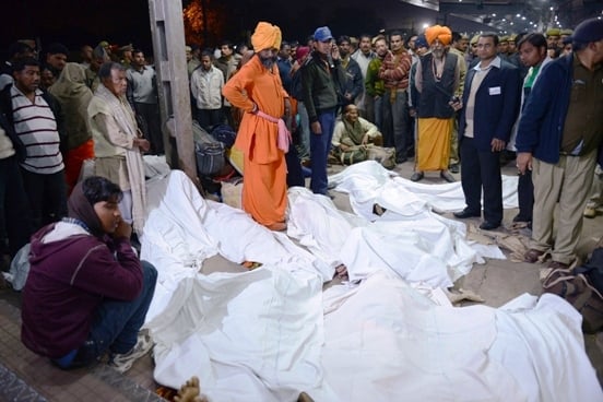 indian authorities stand among some of the travellers that were killed during a stampede at the railway station in allahabad on february 10 photo afp