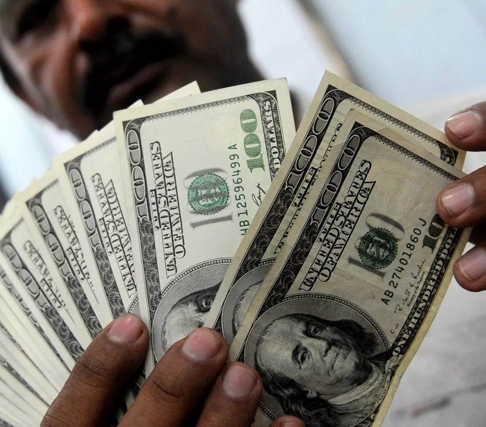 a money dealer counts us dollar notes at a money market in karachi photo afp a money dealer counts us dollar notes at a money market in karachi photo afp