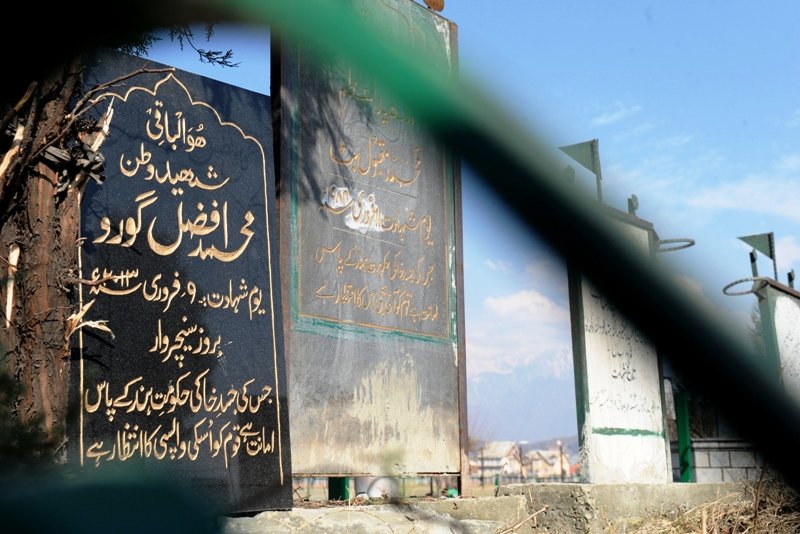 a tomb stone for kashmiri separatist afzal guru l is seen at the martyrs graveyard in srinagar on february 12 2013 photo afp