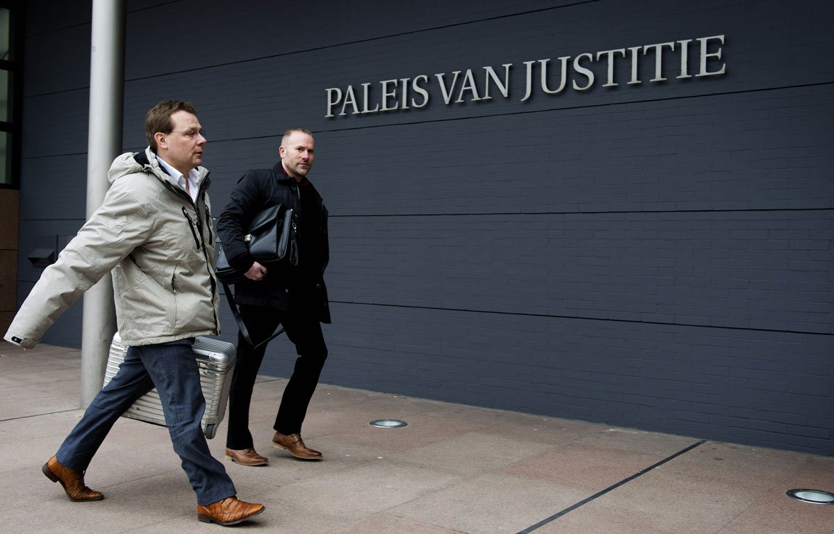 lawyer of pakistani dutch national sabir khan andre seebregts l arrives in the courtroom of the hague on february 12 2013 photo afp