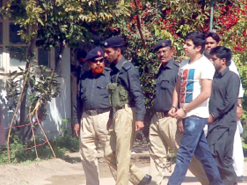 police officials escort shahrukh jatoi for hearing at atc in karachi photo file