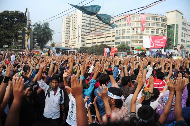 social activists stand in silence and raise their hands at a key intersection in central dhaka on february 12 2013 in protest demanding swift execution of war criminals photo afp