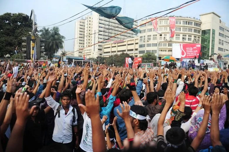social activists stand in silence and raise their hands at a key intersection in central dhaka on february 12 2013 in protest demanding swift execution of war criminals photo afp social activists stand in silence and raise their hands at a key intersection in central dhaka on february 12 2013 in protest demanding swift execution of war criminals photo afp