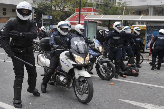 police detains a demonstrator in central athens on december 6 2009 during a massive demonstration commemorating 15 year old alexandros grigoropoulos 039 fatal shooting a year ago photo afp police detains a demonstrator in central athens on december 6 2009 during a massive demonstration commemorating 15 year old alexandros grigoropoulos 039 fatal shooting a year ago photo afp