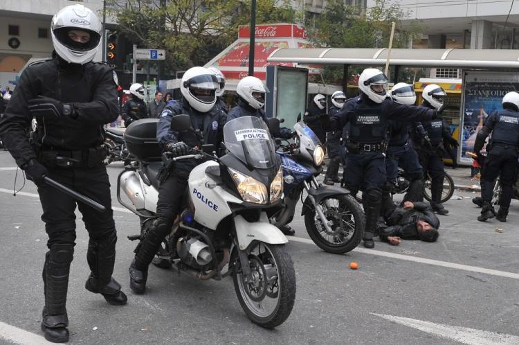 police detains a demonstrator in central athens on december 6 2009 during a massive demonstration commemorating 15 year old alexandros grigoropoulos 039 fatal shooting a year ago photo afp