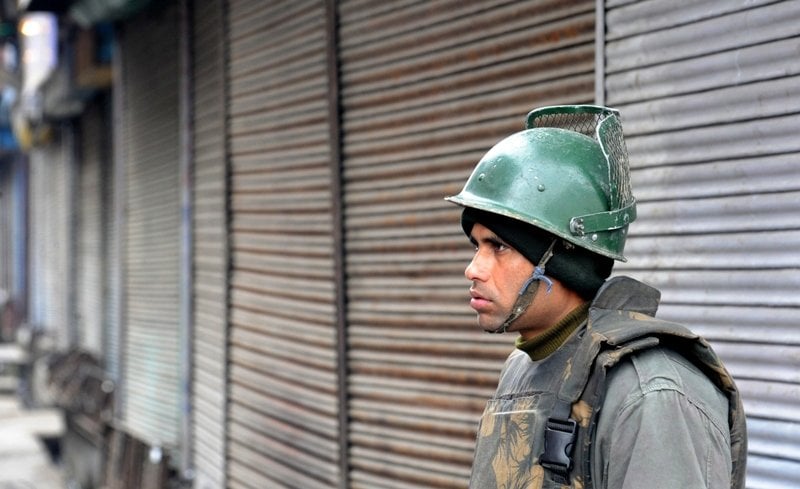 an indian paramilitary soldier stands guard during a strike in srinagar on february 16 2013 photo afp