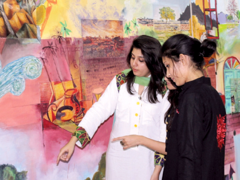 visitors engrossed in the artwork on display at the campus of the shaheed zulfikar ali bhutto institute of science and technology on friday photo press release