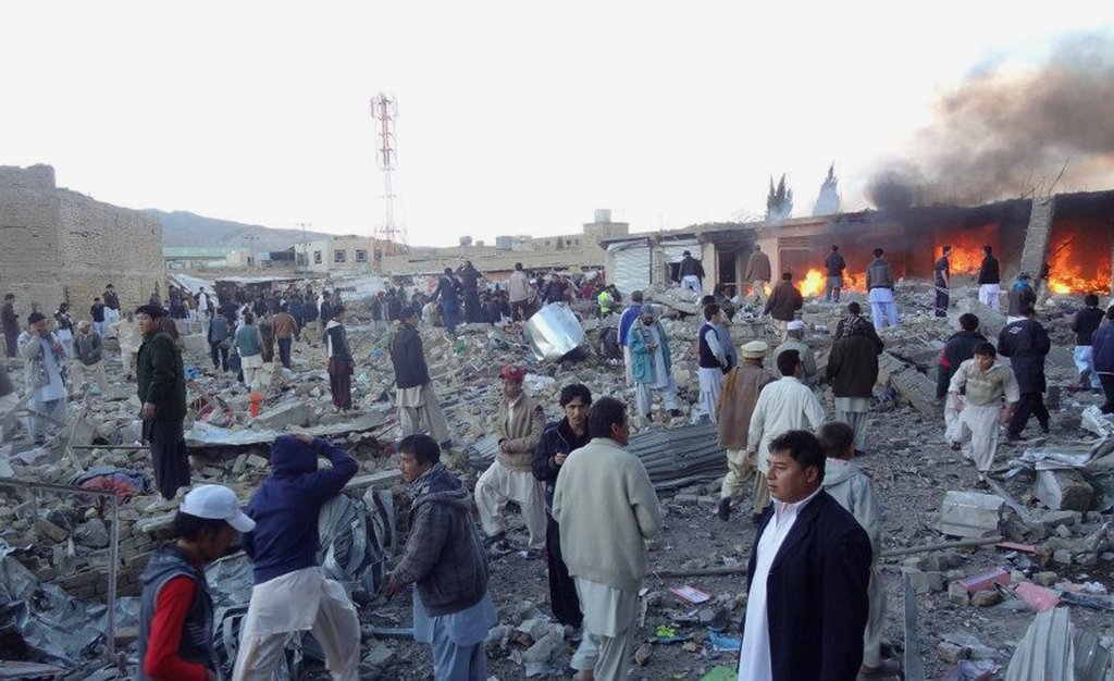 people gather after a bomb targeting shia muslims exploded in busy market in hazara town an area dominated by shias on the outskirts of quetta on february 16 2013 photo afp