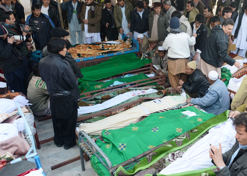 families mourn the death of relatives as they gather with coffins of bomb attack victims during a protest in quetta photo afp