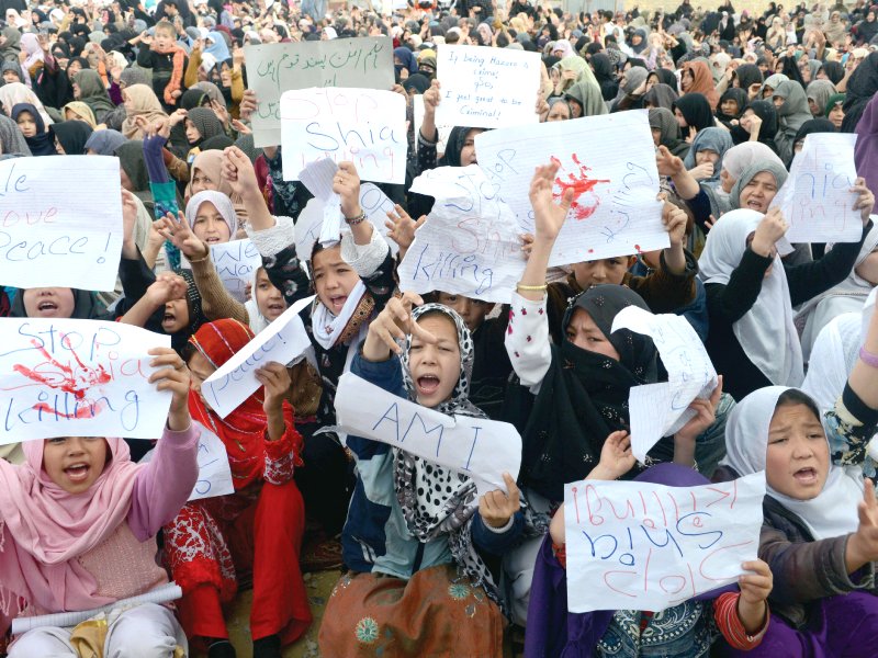 young girls chant slogans on the second day of protests against a devastating bomb attack in quetta on monday photo afp