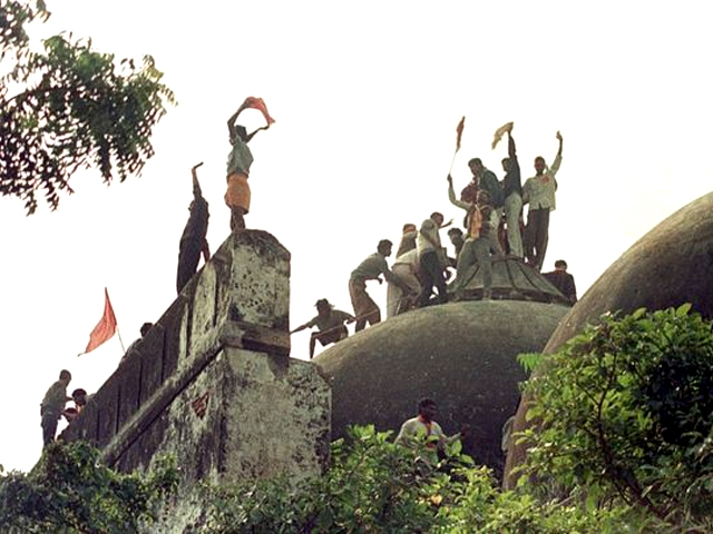 hindu fundamentalists celebrate atop the 16th century babri masjid mosque 06 december 1992 at a disputed holy site in this city the mosque was reduced to rubble after thousands of fundamentalists attacked it with pickaxes hammers and swords photo douglas e curran afp