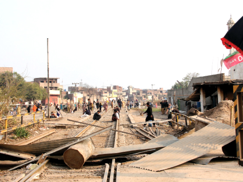 protesters place blockades on rail tracks at imamia colony photo abid nawaz shafiq malik express