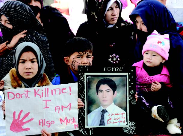 children display signs during the third day of protests in quetta photo afp