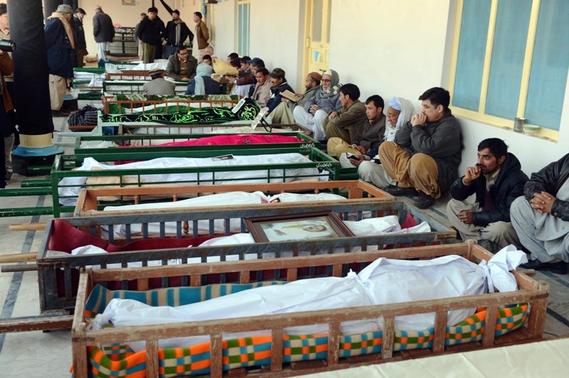 file photo of shia muslim mourners sit beside the coffins of blast victims at a mosque photo afp file
