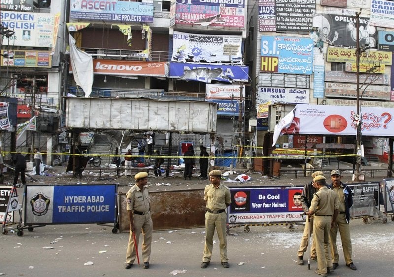 policemen stand guard as forensic officials inspect the site of an explosion at dilsukh nagar in the southern indian city of hyderabad photo reuters krishnendu halder