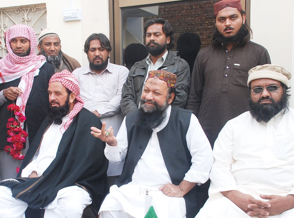 a photo of malik ishaq addressing a press conference on february 22