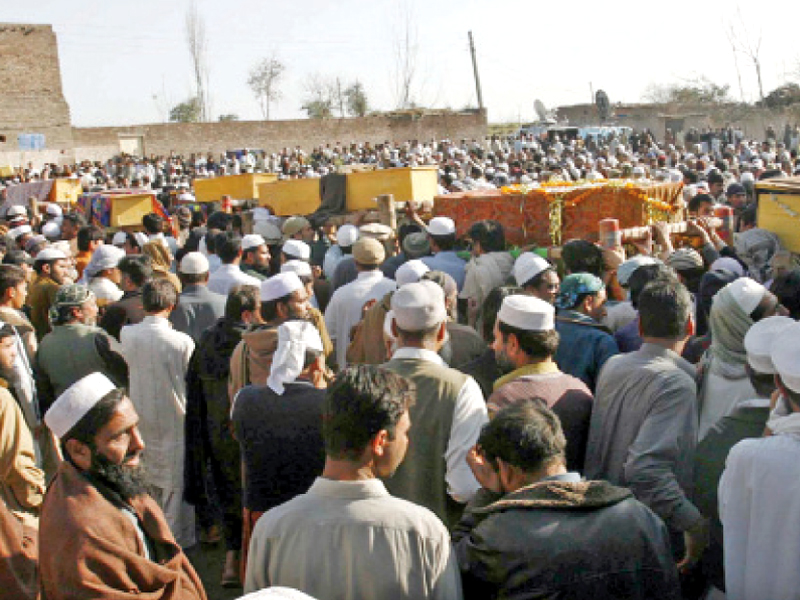 people carry coffins of those who died on friday when a passenger bus plunged into budhani canal photo ppi