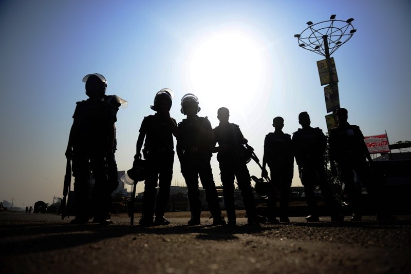 bangladeshi police personnel stand guard during a nationwide strike in dhaka on february 24 2013 photo afp