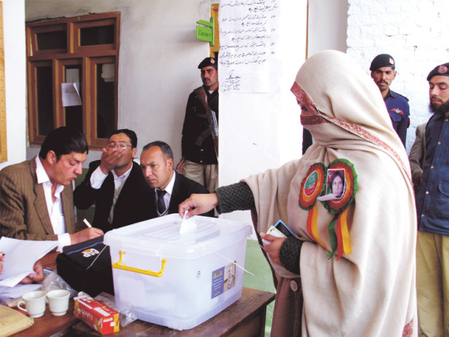 a woman casting vote at a polling station in swat photo express a woman casting vote at a polling station in swat photo express