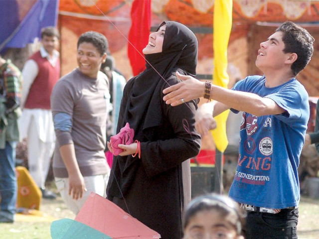 a young man engaged in a kite battle photo inp