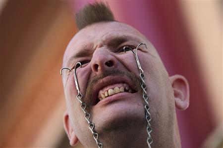 about a 100 passers by gathered with anticipation as the performers swallowed steel photo reuters